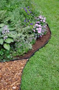 32 Super Cheap and Quirky Garden Edging with Wood Chip Mulching inside Black Plastic Borderline