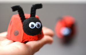Adorable Easy Egg Carton Ladybugs with Yarn Pom-Pom Head and Pipe Cleaner Strings