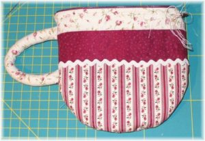 Tea-Cup Pouch Project with Quilting Fabric and Lace Embellishments with a Fluffy Handle