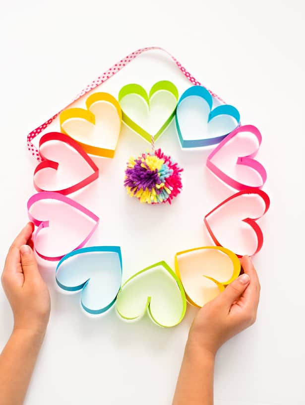 Colorful DIY Rainbow Paper Heart Wreath with Catchy Pom-Pom Center