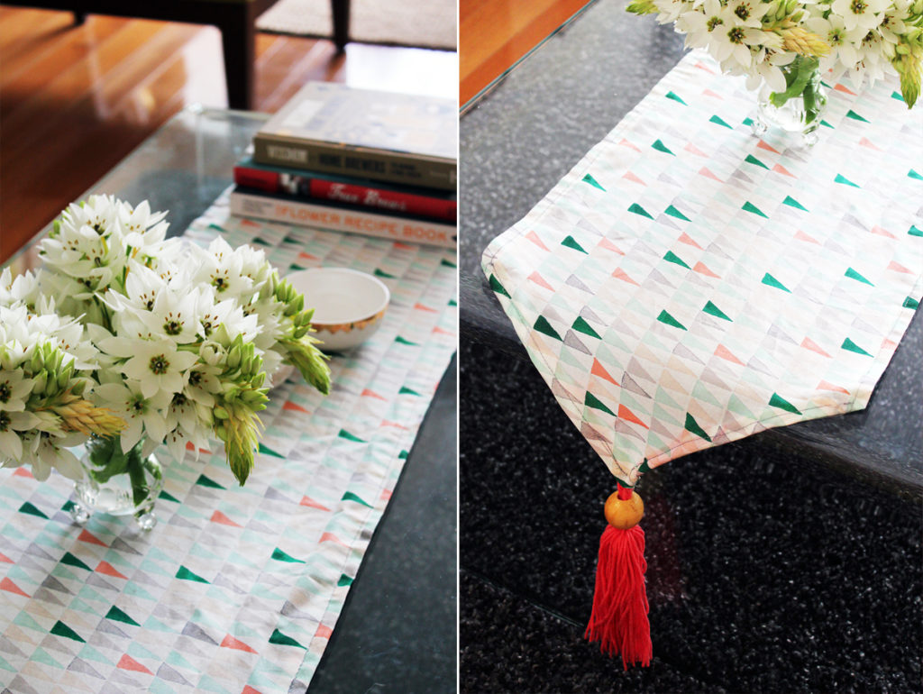DIY Tasseled Table Runner with a Fancy Wooden Ball Decor Beneath The Cotton Made Base