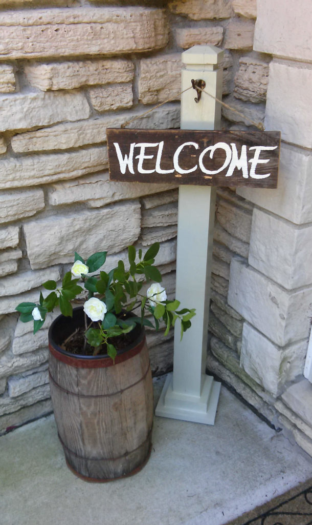 DIY Doorway Decor with Welcome Sign and A Pretty Gardenia Plant Decor Inside Barrel Planter