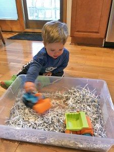 Construction Site Sensory Bin Activity with Toy Truck and Roughly Shredded Paper Scraps