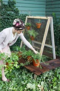 Totally Rustic Farm-Style Vertical Herb Gardening Idea with Upcycle Two-Salvaged Screens on bar  ...