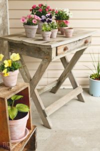 Summer Front Porch Decor Idea with WhitewashedTerra Cotta Pot And A Rustic Wooden Plant-Holder