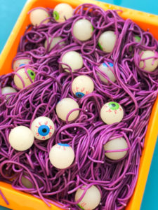 Make Halloween Sensory Bin with easy Colored Spaghetti & Glow in Dark Bouncy Eyeball
